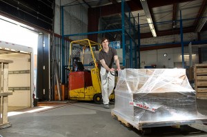 warehouse worker pushing a pallet jack