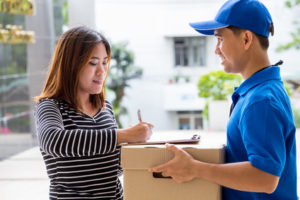 woman signing receipt of delivered package