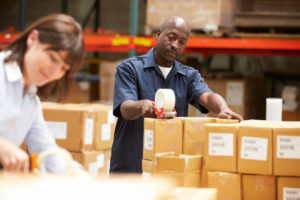 Workers In Warehouse Preparing Goods For Dispatch