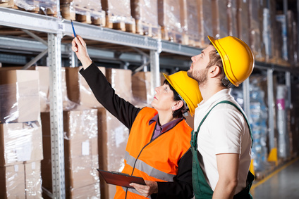 Warehouse Manager Instructing Worker